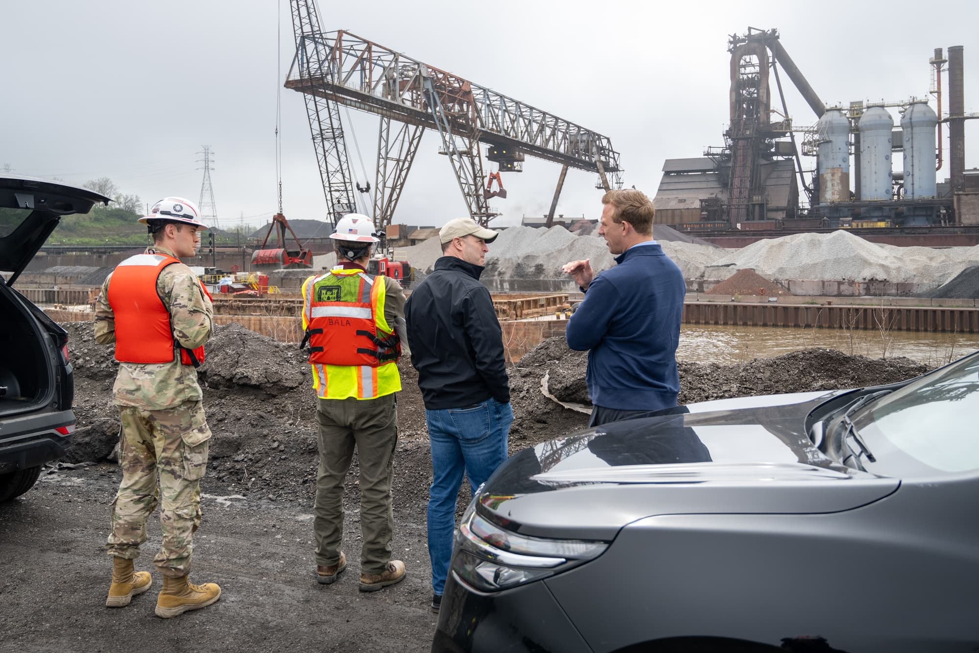 Federal construction site with workers supporting government facility oversight and construction contract compliance monitoring
